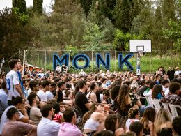 people sitting in basketball field with countryside in the background at monk roma xceed