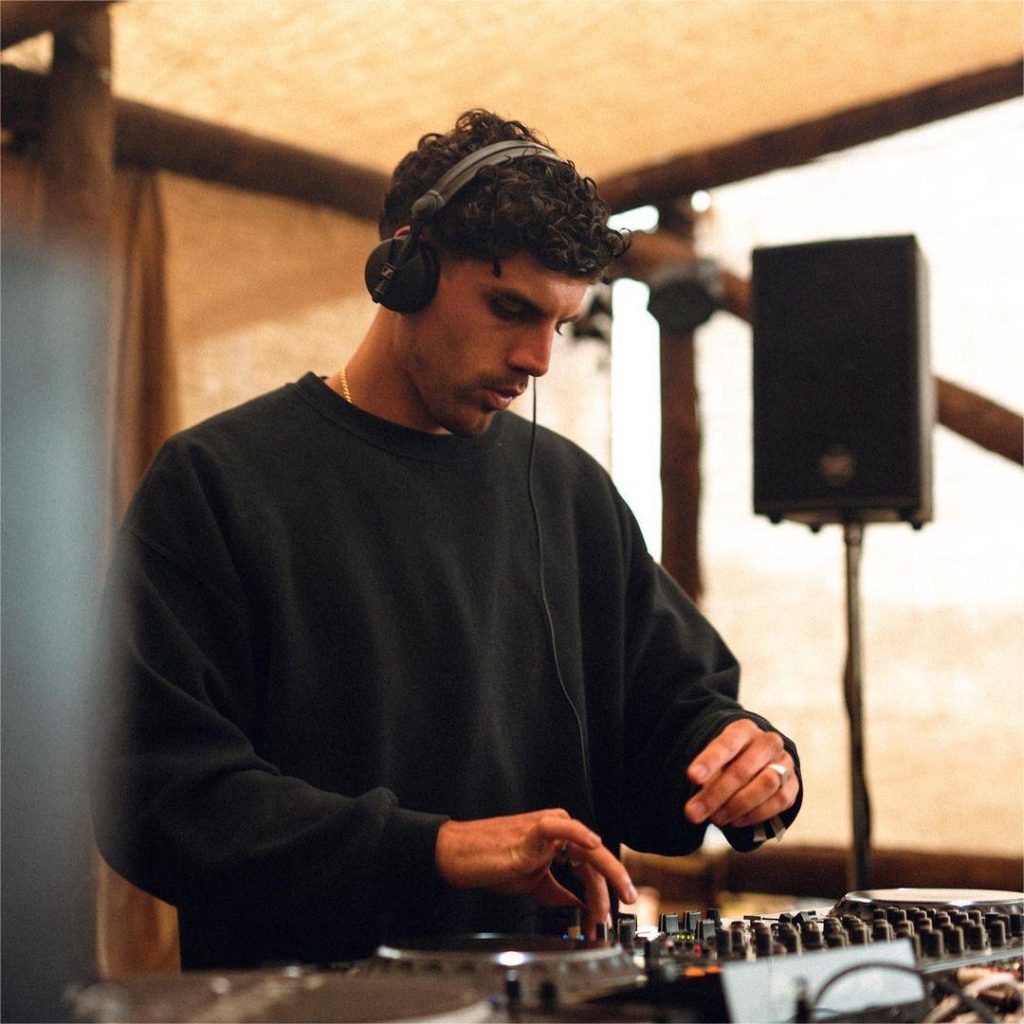 Jean Mauj DJing at an outdoor venue with a focused expression, featured in XCEED’s industry analysis.