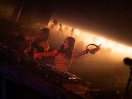 Two DJs performing in a dynamic, immersive club setting, showcasing the energy and creativity defining electronic music trends in 2025, featured in XCEED’s insights